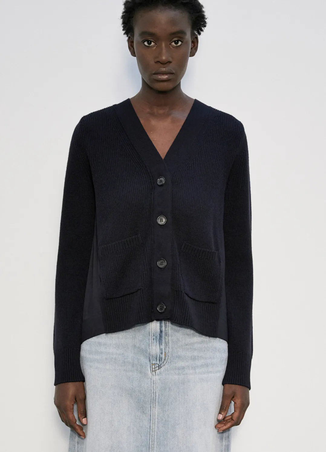 RIBBED CARDIGAN WITH POCKETS AND PLEATED FABRIC AT THE BACK